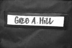 Close up of a name card holder saying GREG A. HILL